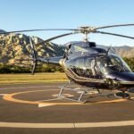 Luxury helicopter on a helipad in a scenic location.