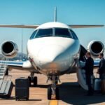 Private jet with staff assisting travelers at airport.