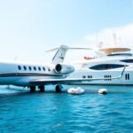 Private jet and yacht in a luxurious travel setting.