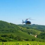 Helicopter flying over scenic vineyards and rolling hills.