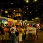 a crowd of people standing around a food truck